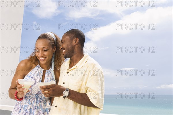 Couple having drinks on balcony