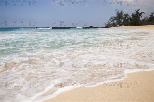 Waves washing up on tropical beach