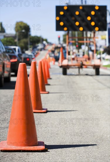 Close up of traffic cones on busy street