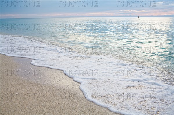 Mixed race woman standing on paddleboard in ocean