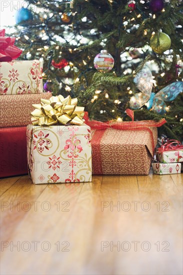 Close up of wrapped gifts under Christmas tree