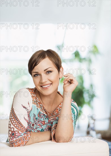 Caucasian woman smiling on sofa