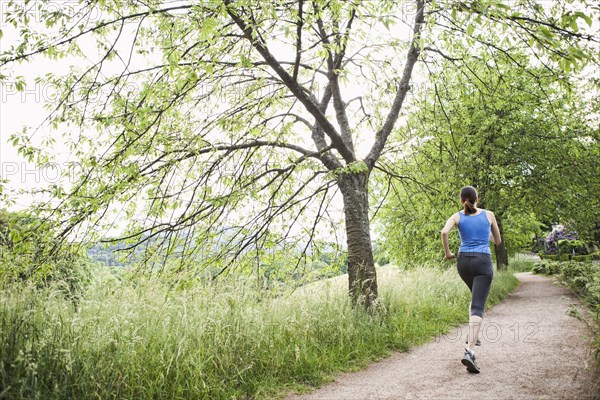 Mixed race woman running on path