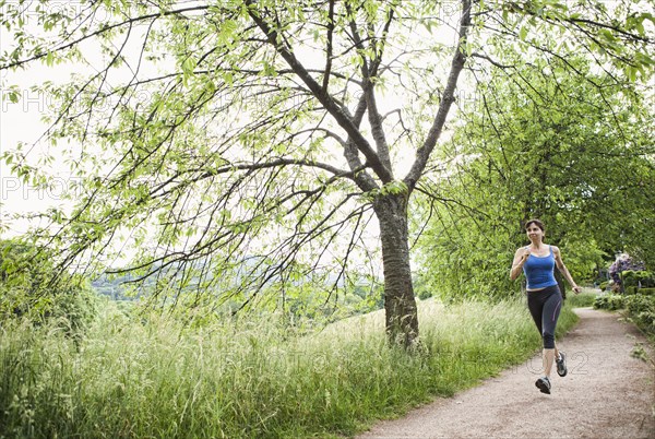 Mixed race woman running on path