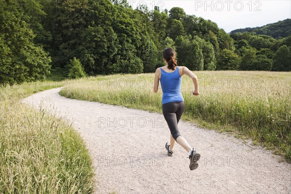 Mixed race woman running on path