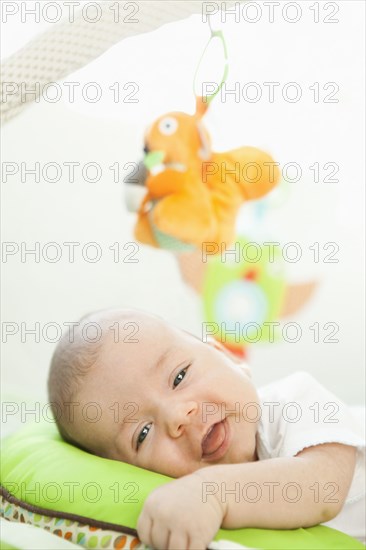 Mixed race  baby laying on pillow
