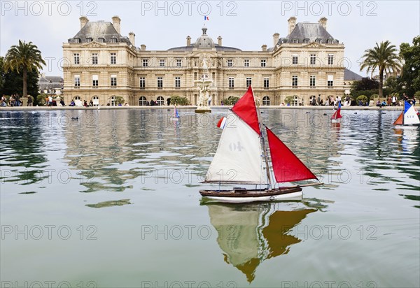 Boat floating in courtyard pond