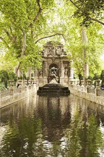 Ornate statue over park stream