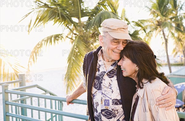 Older couple hugging outdoors