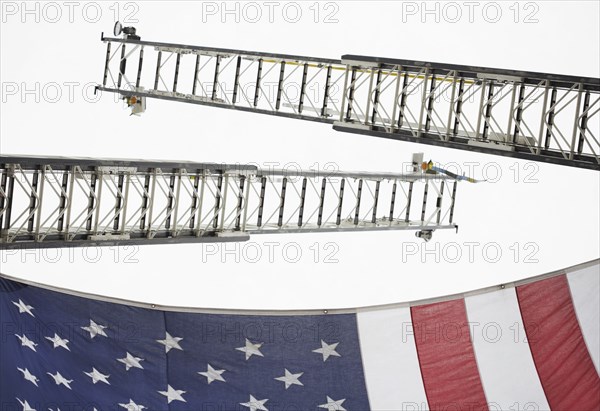 Low angle view of crane ladders and American flag