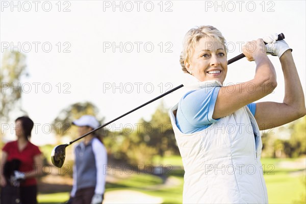 Woman playing golf on golf course