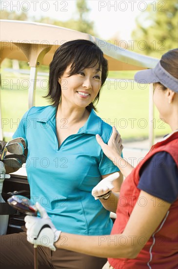 Women talking on golf course