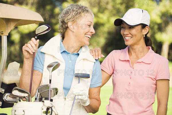 Women laughing on golf course