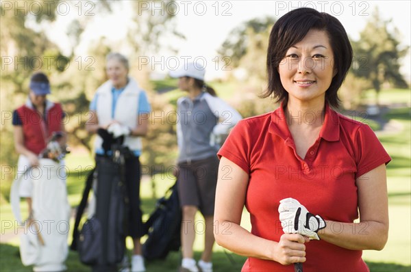 Women playing golf on golf course