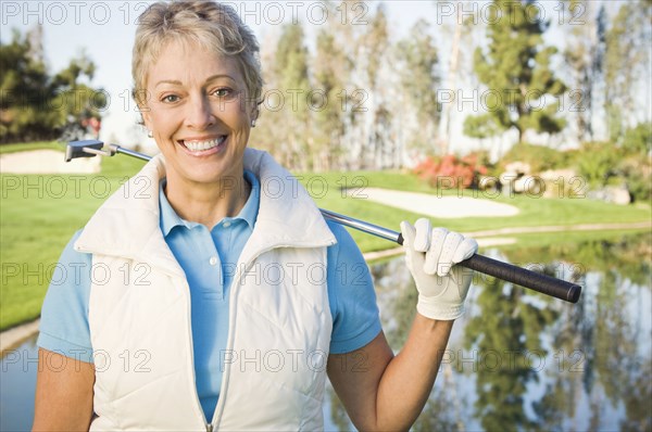 Caucasian woman smiling on golf course