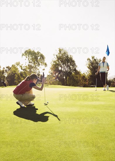 Caucasian women playing golf on golf course