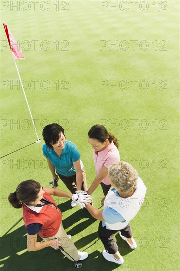 Women celebrating on golf course