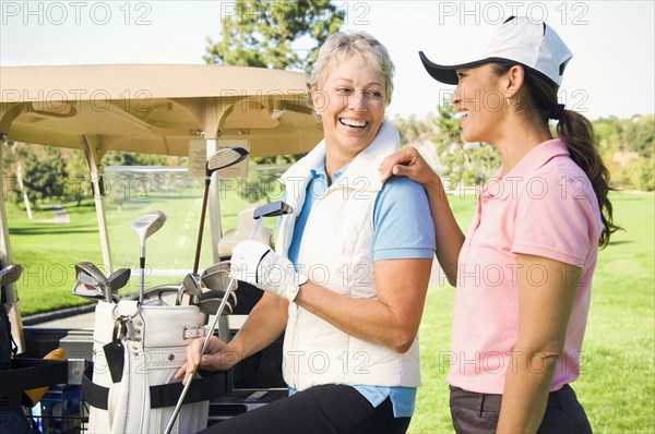 Women laughing on golf course