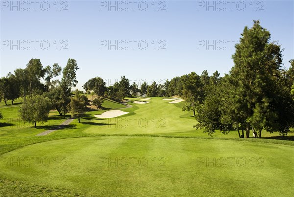 High angle view of golf course under blue sky