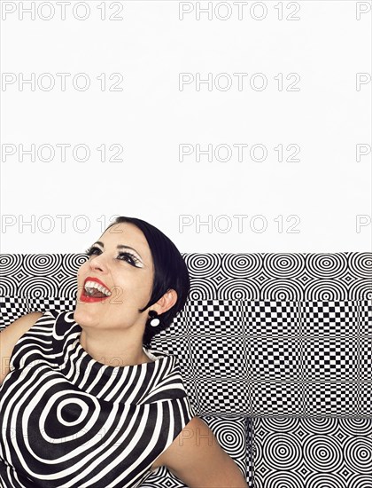 Laughing woman wearing retro patterned dress