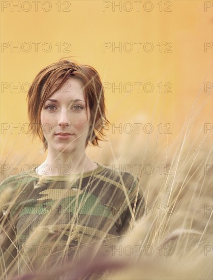 Caucasian woman standing in tall grass