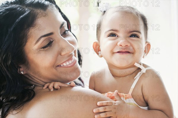 Mixed Race mother holding baby daughter