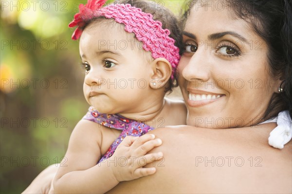 Mixed Race mother holding baby daughter