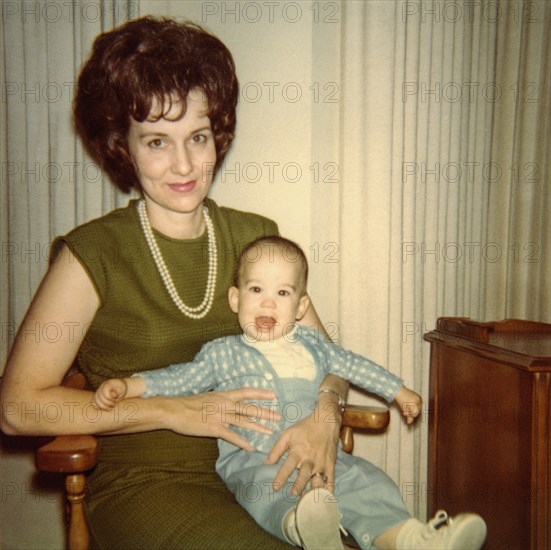 Caucasian mother sitting in chair holding baby son