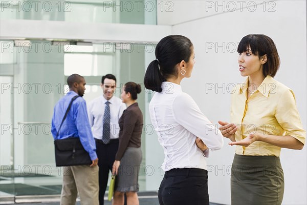 Business people talking in lobby