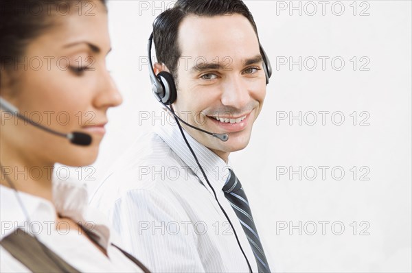 Customer service representatives wearing headsets