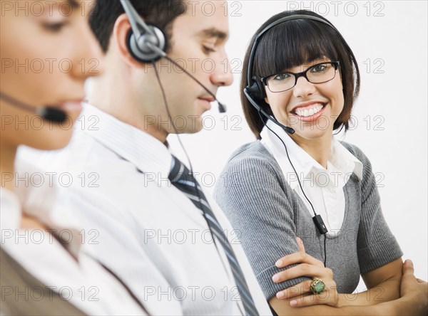 Customer service representatives wearing headsets
