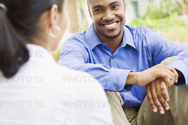 Smiling business people talking outdoors