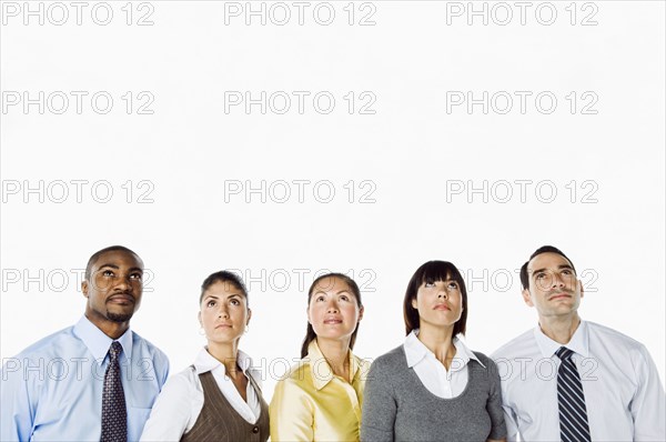 Portrait of curious business people looking up