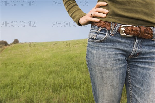 Midsection of Mixed Race woman standing in field