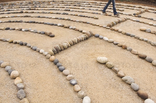 legs of Mixed Race woman walking in maze