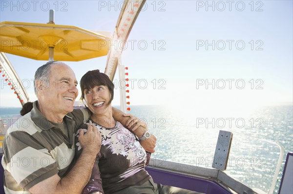 Senior couple sitting near ocean