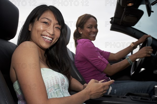 Friends driving in convertible