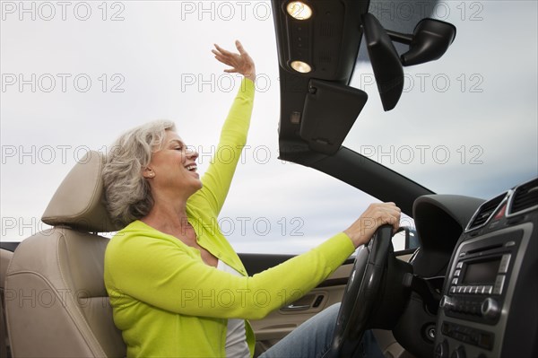 Caucasian woman driving convertible