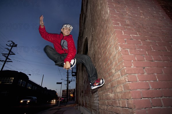 Pacific Islander man breakdancing in urban area