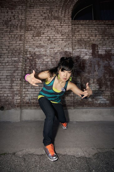 Chinese woman breakdancing in urban area