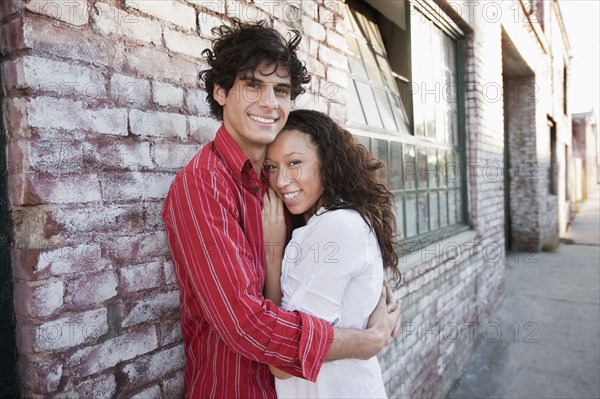 Couple hugging in urban area