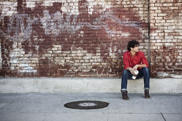 Native American man drinking coffee in urban area