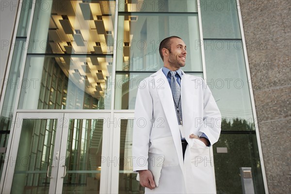 Doctor holding digital tablet outdoors