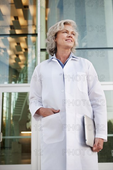 Doctor holding digital tablet outdoors
