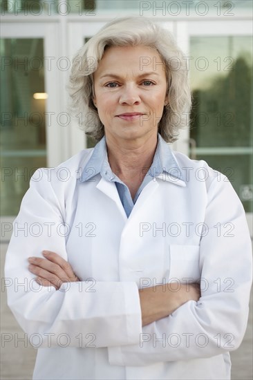 Smiling doctor standing outdoors