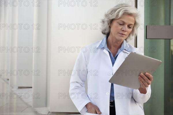 Doctor using digital tablet outdoors