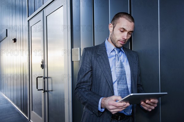 Businessman using digital tablet outdoors