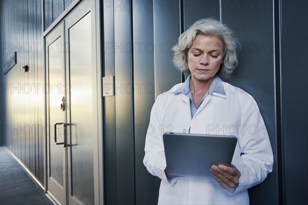 Doctor using digital tablet outdoors