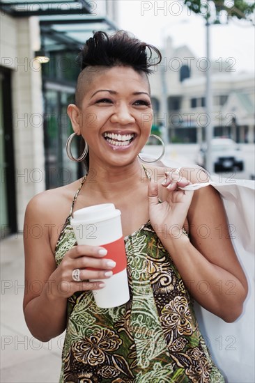 Asian woman shopping and drinking coffee