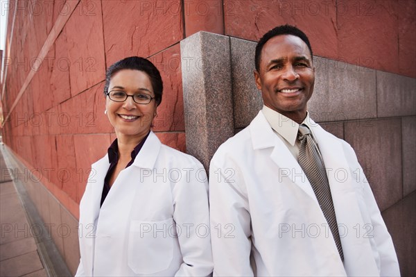 Smiling doctors standing outdoors